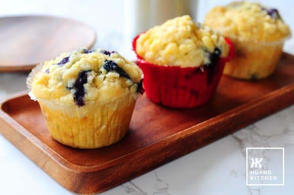 Buttery Blueberry Streusel Muffins Recipe by Huang Kitchen - close up view of muffins with latter in the background