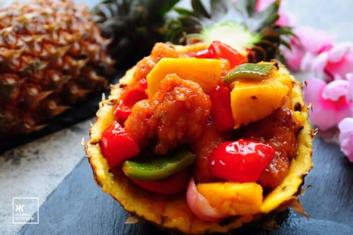 Sweet and sour pineapple pork ribs served in pineapple shell